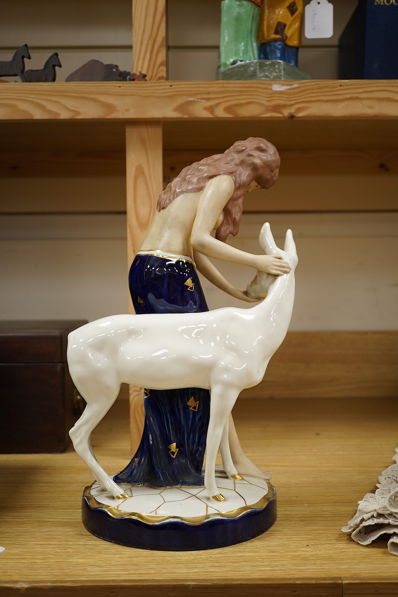 A Royal Dux Art Deco porcelain group of girl with a deer 37.5cm high